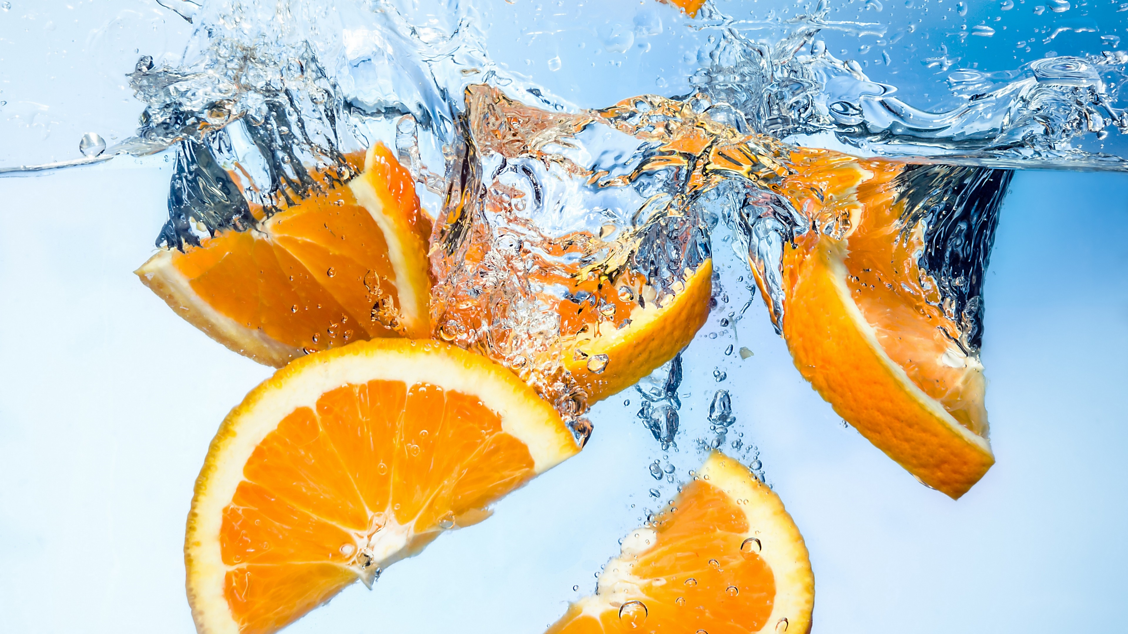 oranges splashing in water